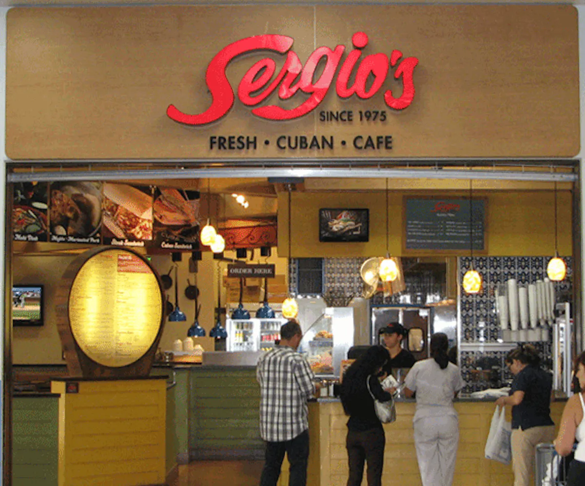 a group of people standing in front of a store